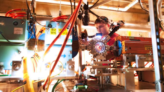 A graduate student works on a particle accelerator at the SLAC National Accelerator Laboratory