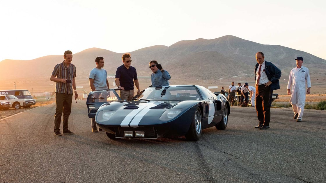 Ford racing team members gathered around a GT40 in Ford v Ferrari