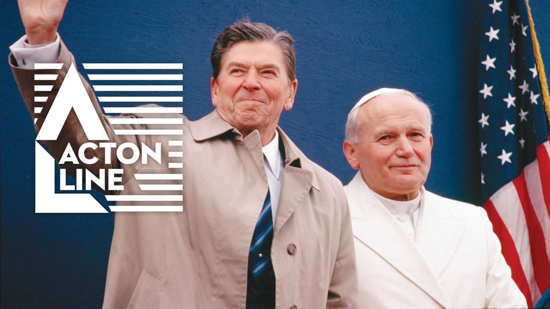 Pope John Paul II and President Ronald Reagan pose for the cameras in front of an American flag