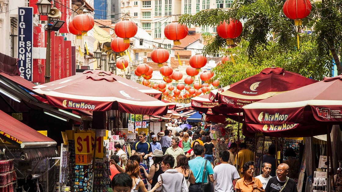 Shoppers browse goods at a Chinatown market in Singapore